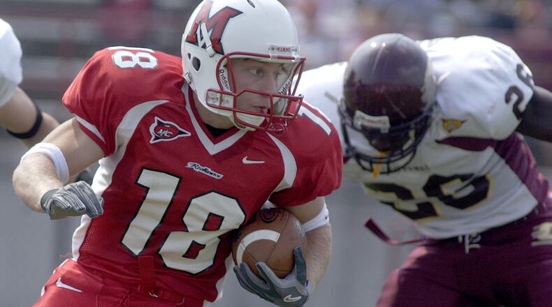 CAMERON KNIGHT/for the JOURNALNEWS Miami University wide receiver Sean McVay fights off Central Michigan linebacker Jonathan Lapsley during the first half of the Saturday game in Yager Stadium.  The Redhawks were defeated the Chippewas 38 - 37.