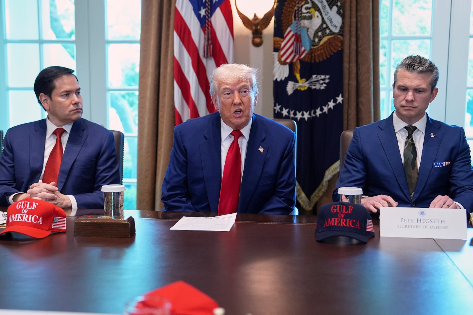 President Donald Trump speaks during a cabinet meeting at the White House, Wednesday, April 30, 2025, in Washington, as Secretary of State Marco Rubio, left, and Secretary of Defense Pete Hegseth, look on. (AP Photo/Evan Vucci)
