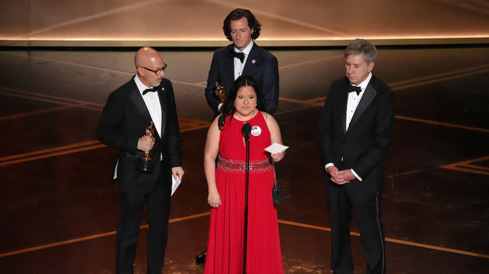 Joshua Seftel, from left, Gloria Cazares, Conall Jones, and Steve Hartman accept the award for documentary short film for "All the Empty Rooms" during the Oscars on Sunday, March 15, 2026, at the Dolby Theatre in Los Angeles. (AP Photo/Chris Pizzello)