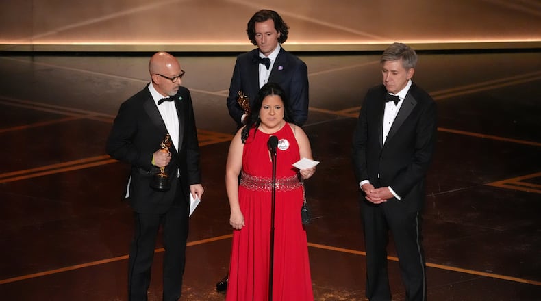 Joshua Seftel, from left, Gloria Cazares, Conall Jones, and Steve Hartman accept the award for documentary short film for "All the Empty Rooms" during the Oscars on Sunday, March 15, 2026, at the Dolby Theatre in Los Angeles. (AP Photo/Chris Pizzello)