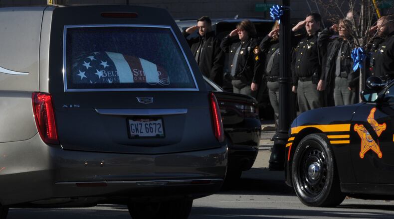 Greene County deputies salute as the procession for Sheriff Gene Fischer goes by the Sheriff's Office in Xenia Tuesday, Nov. 23, 2021. MARSHALL GORBY\STAFF