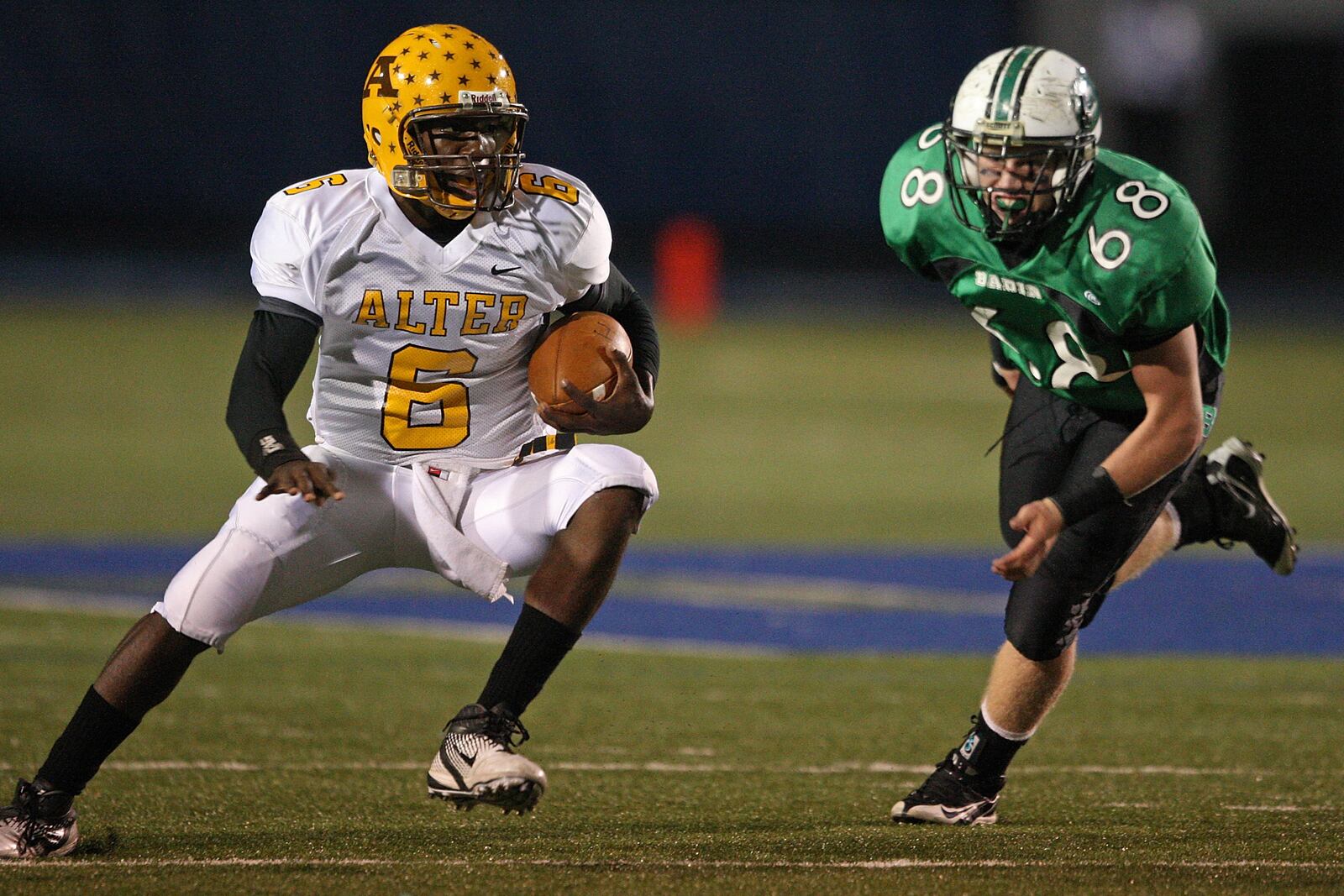 Alter's Malik Zaire (5) makes a cut en route to a touchdown while Badin's Jack Fetters is in pursuit Sept. 24, 2011, at Virgil Schwarm Stadium in Hamilton. Alter and Badin are both moving up to Division III in football in the fall thanks to the Ohio High School Athletic Association's new competitive balance regulations. JOURNAL-NEWS FILE PHOTO