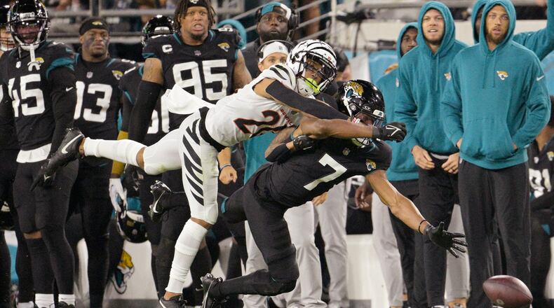 Cincinnati Bengals cornerback DJ Turner II (20) breaks up a pass intended for Jacksonville Jaguars wide receiver Zay Jones (7) during the second half of an NFL football game, Monday, Dec. 4, 2023, in Jacksonville, Fla. (AP Photo/Phelan M. Ebenhack)