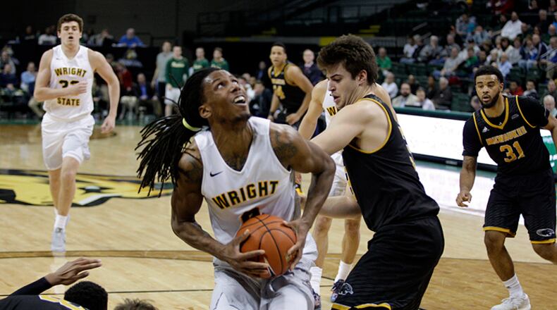 February 9,2017: Wright State’s Steven Davis (0) looks to shoot over Milwaukee’s Brock Stull during their game Thursday night at the Nutter Center in Fairborn, Ohio. TIM ZECHAR / CONTRIBUTED
