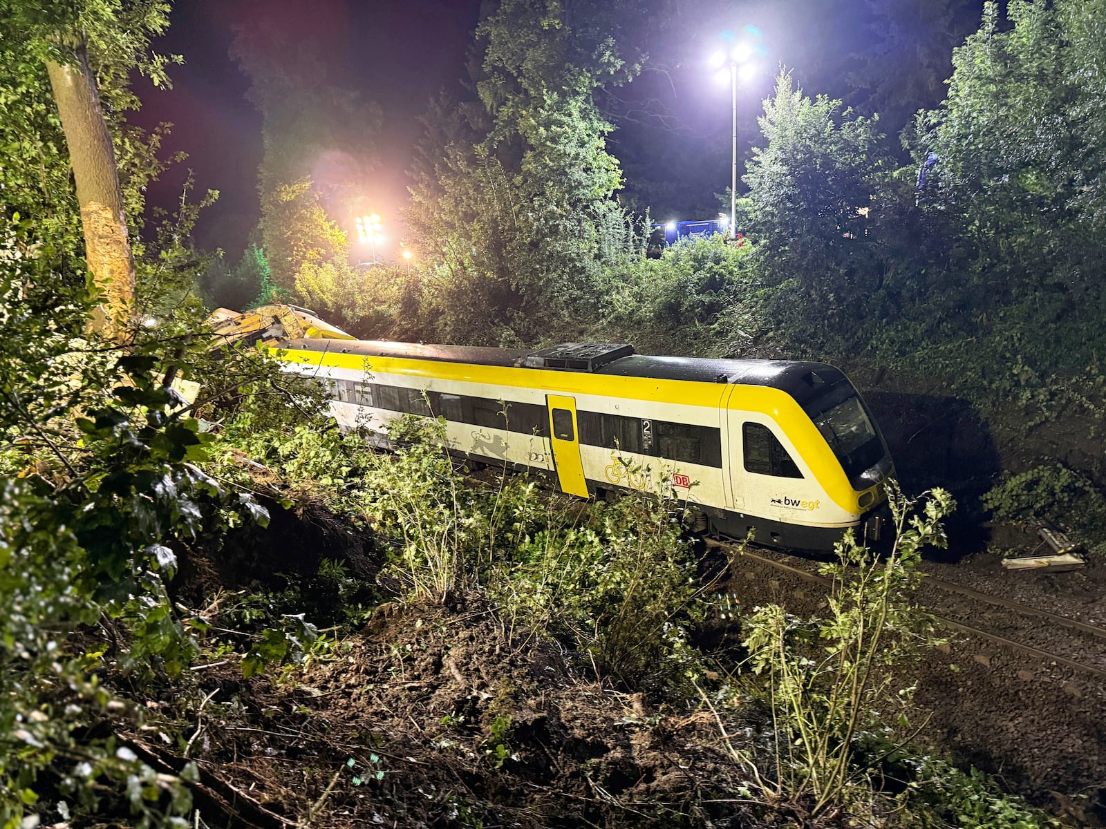 A carriage of the derailed regional passenger train stands on a section of track near Riedlingen, Germany, Sunday, July 27, 2025. (Nico Pointner/dpa via AP)