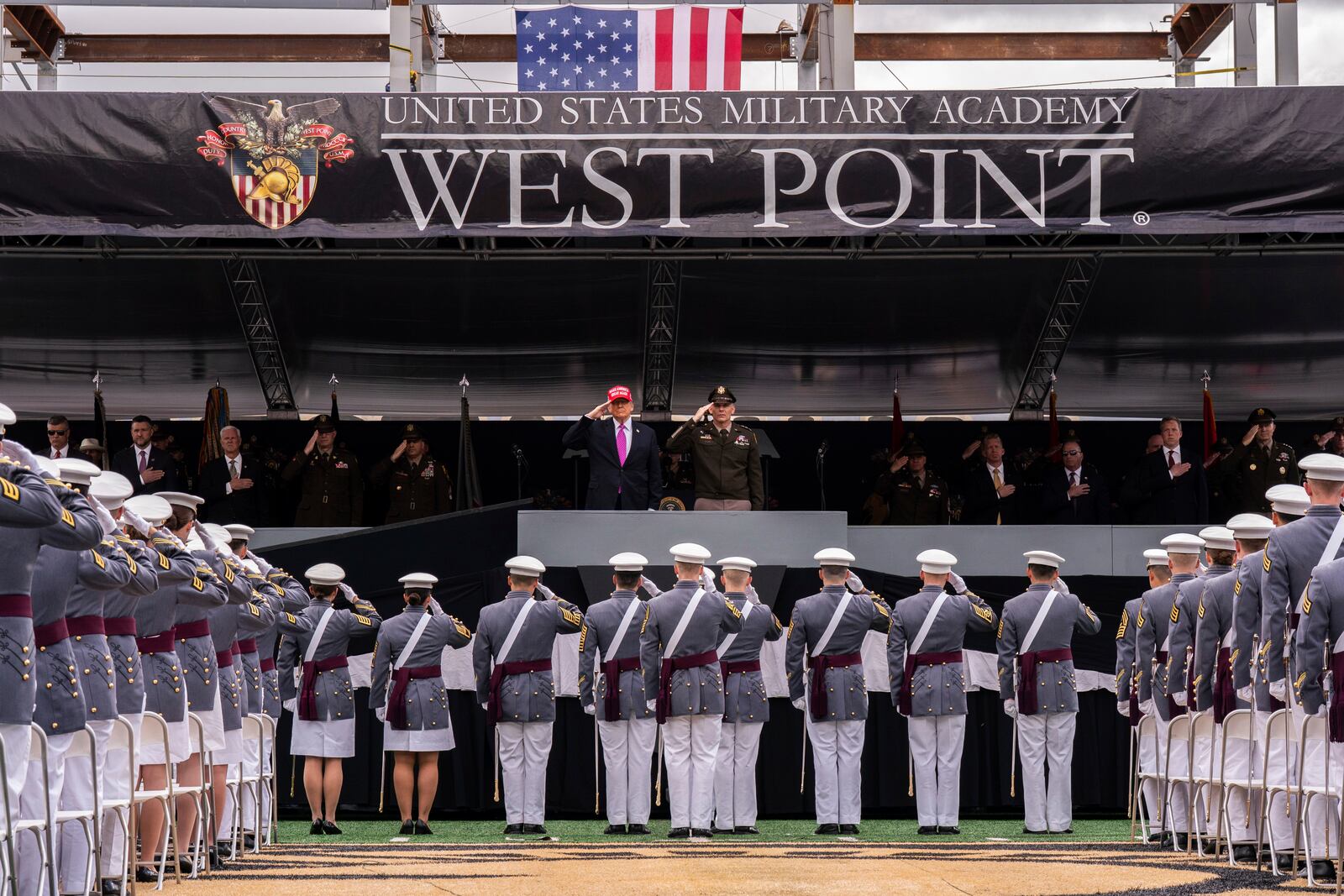 President Donald Trump salutes alongside Lieutenant General Steven W. Gilland during the U.S. Military Academy commencement ceremonies in West Point, N.Y., Saturday, May 24, 2025. (AP Photo/Adam Gray)