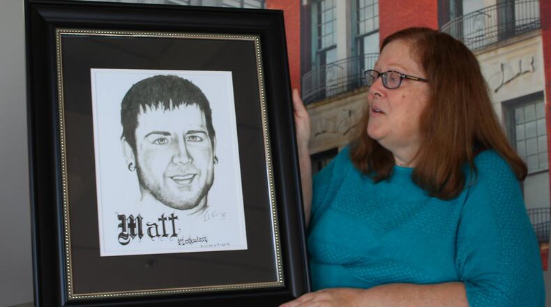 Jerri Jackson, the mother of Matt McQuinn who was killed in 2012 during the Aurora, Colo. theater shooting, is shown with a picture of her late son. JEFF GUERINI/STAFF