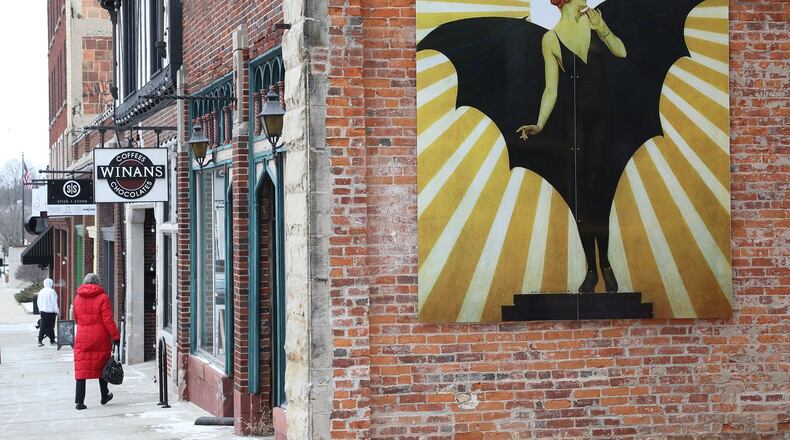 A mural image of a ”bat girl” created by a Springfield native C. Coles Phillips for LIFE Magazine in the 1920s, graces the side of the Pappas Building on Fountain Ave., the first of a series of murals that will become part of a larger project to beautify the city with more public art. BILL LACKEY/STAFF