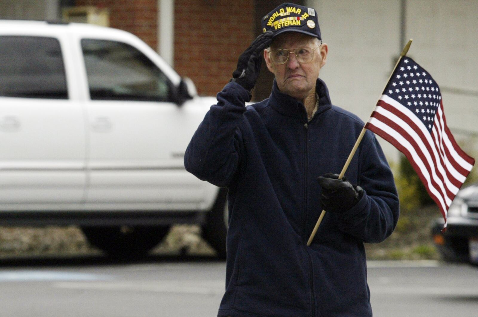 Veteran Dick Chenault of Springboro salutes Staff Sgt. Travis Griffin, the U.S. airman killed in Iraq, as his funeral procession goes through Main Street in Springboro on Saturday April 12. Staff Photo by Teesha McClam