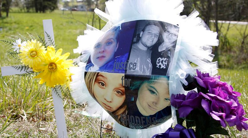 A memorial that reads "Justice for the Rhodens" sits along Union Hill Rd.as the investigation in the execution-style killing of eight people in Pike County continues.. TY GREENLEES / STAFF