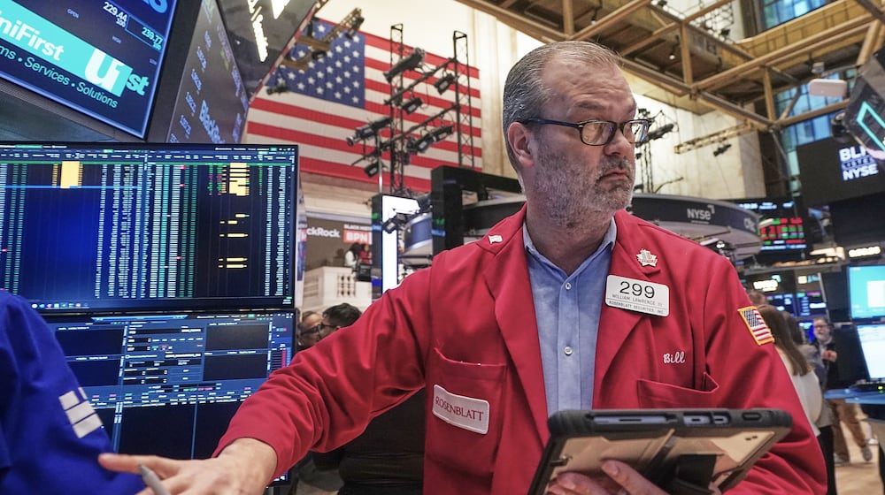 Trader William Lawrence works on the floor of the New York Stock Exchange, Friday, Feb. 13, 2026, in New York. (AP Photo/Richard Drew)