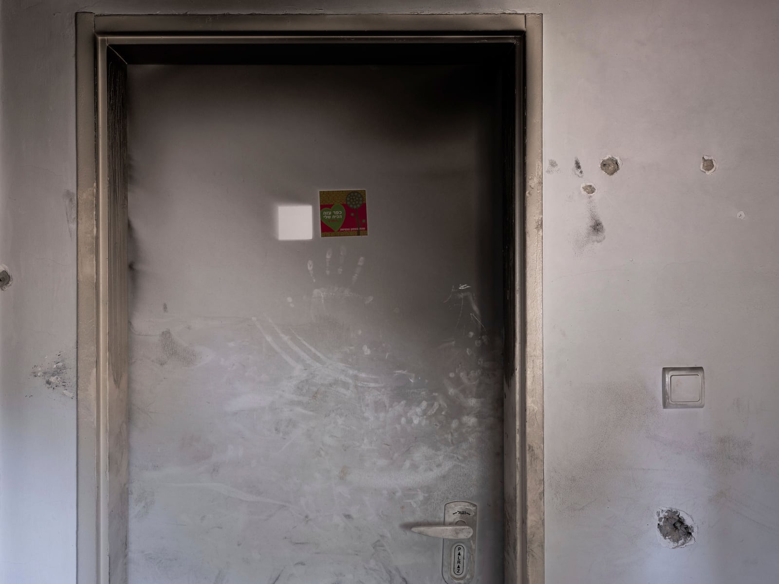 Bullet holes and smoke damage are seen in the bedroom of Ziv Berman, 26, in Kibbutz Kfar Aza, Israel, on Monday, June 24, 2024. Berman and his twin brother, Gali, were abducted on Oct. 7, 2023. (AP Photo/Oded Balilty, File)