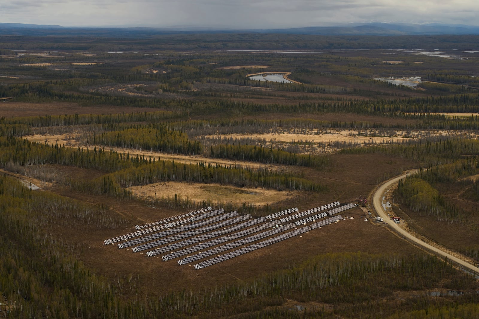 Workers install panels for a solar energy project Wednesday, May 21, 2025, in Galena, Alaska. (AP Photo/John Locher)