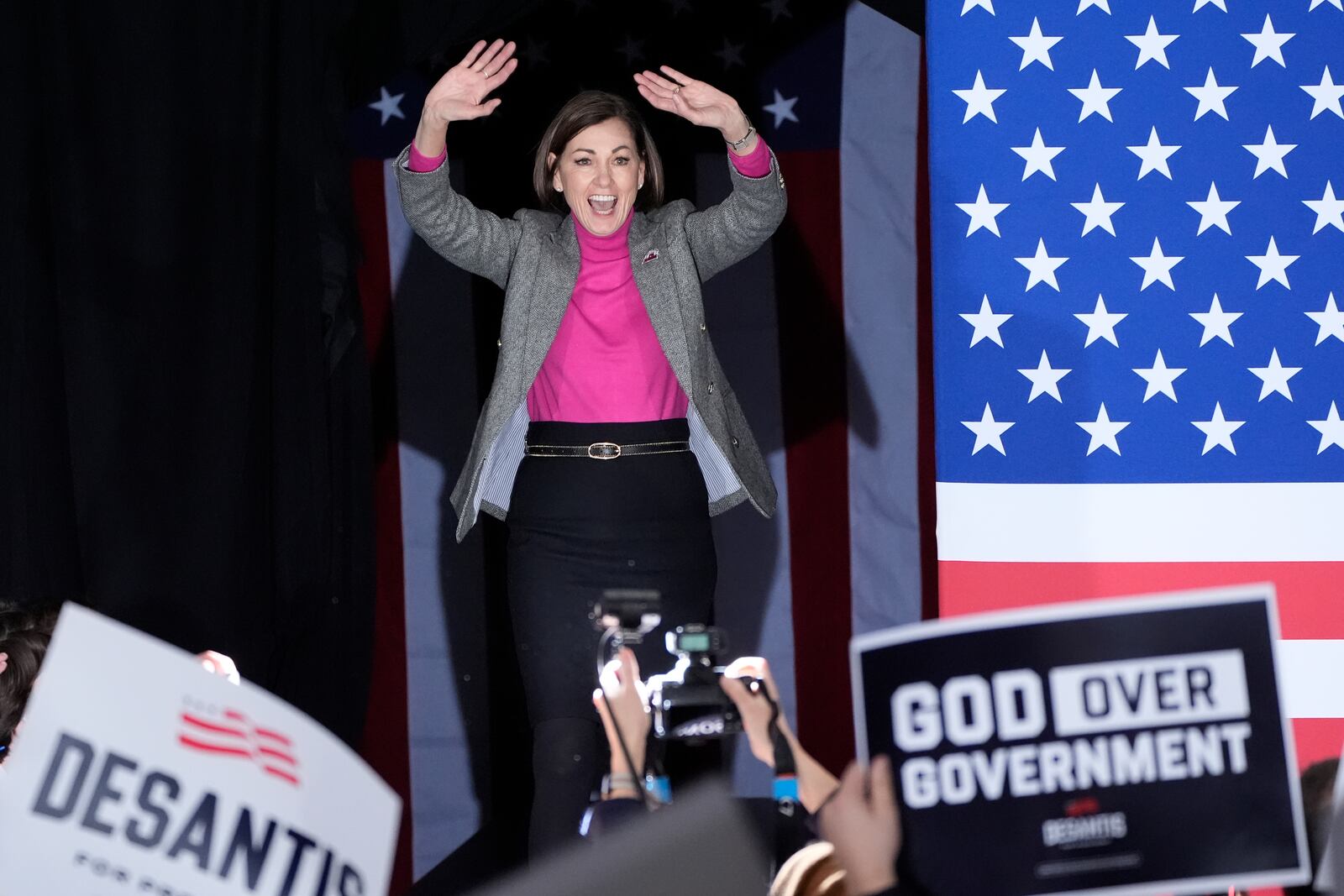 FILE - Iowa Gov. Kim Reynolds arrives on stage with Republican presidential candidate Florida Gov. Ron DeSantis before he speaks to supporters during a caucus night party, Jan. 15, 2024, in West Des Moines, Iowa. (AP Photo/Charlie Neibergall, File)