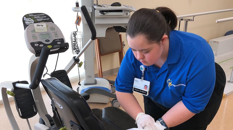 Katie Terry, one of the students in the Project SEARCH program at Springfield Regional Medical Center, cleans the equipment in the Rehab Center at the hospital Wednesday, April 4, 2018. Bill Lackey/Staff