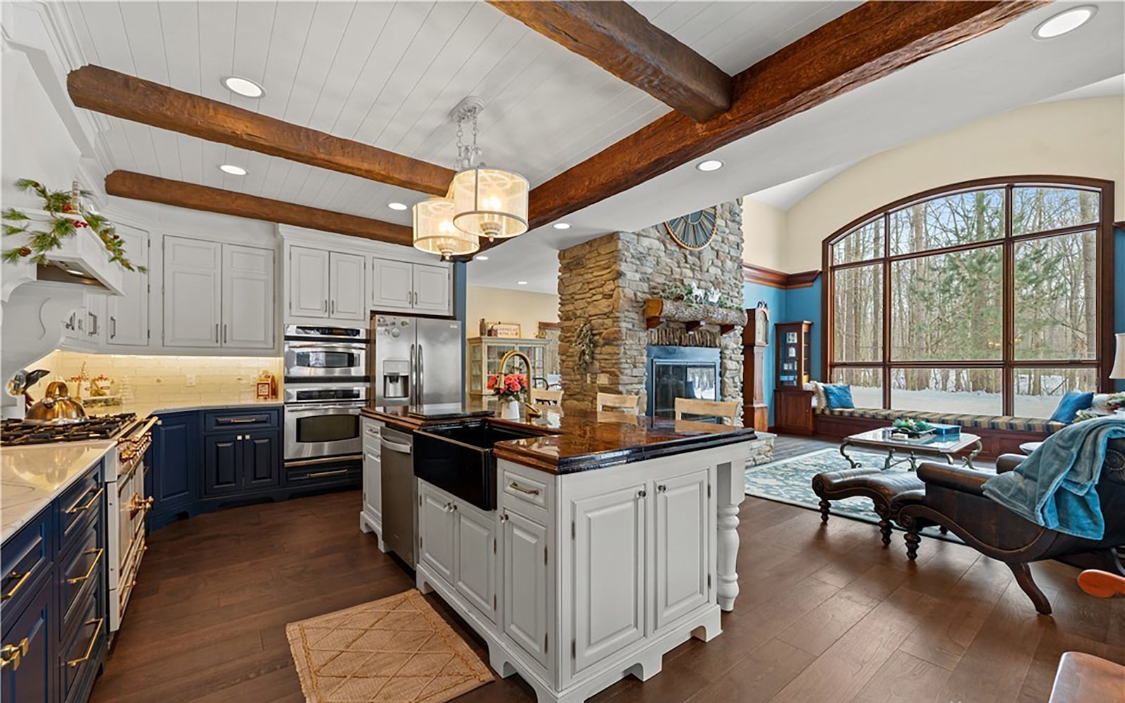 The updated kitchen features hardwood flooring, quartz countertops and a tile backsplash, roughhewn beams on the ceiling and an island with a walnut top. It also has updated professional style appliances. CONTRIBUTED