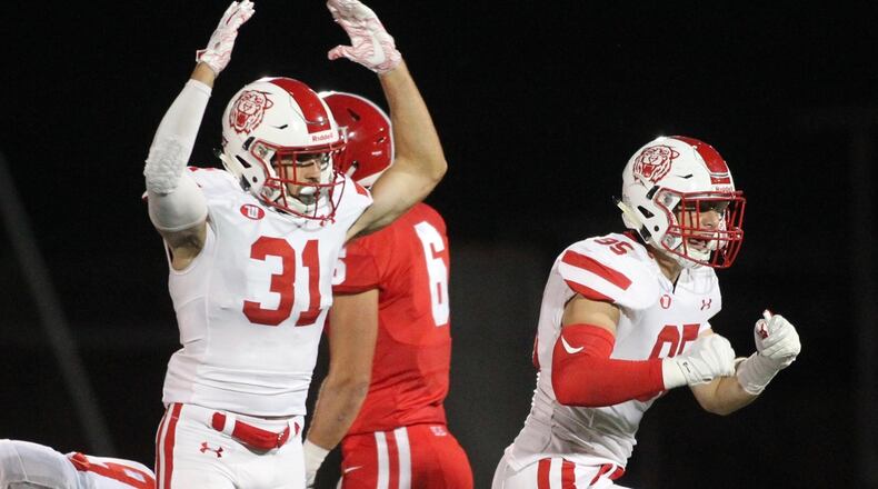 Wittenberg’s Michael Ford, left, and Grant Sparks celebrate a stop against Denison on Saturday, Sept. 29, 2018, at Deeds Field in Granville. David Jablonski/Staff