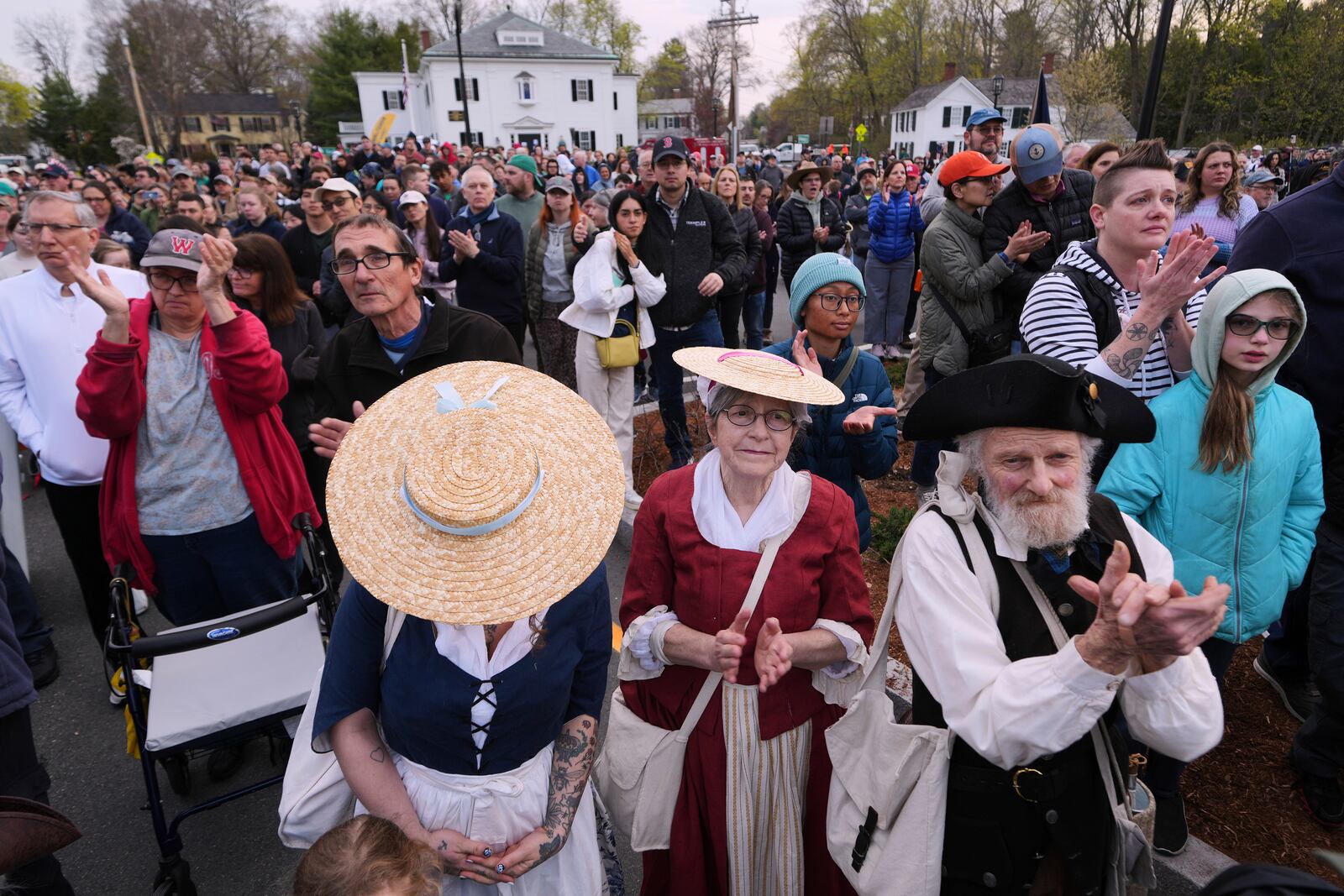 Thousands, some dressed in period clothing, watch a reenactment celebration of the 250th anniversary of the Battle of Lexington and start of the American Revolution, Saturday, April 19, 2025, in Lexington, Mass. (AP Photo/Charles Krupa)