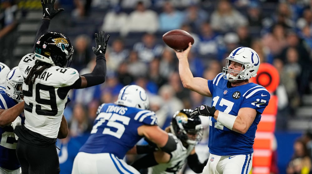 Indianapolis Colts quarterback Philip Rivers (17) throws under pressure from Jacksonville Jaguars safety Eric Murray (29) during the second half of an NFL football game Sunday, Dec. 28, 2025, in Indianapolis. (AP Photo/Carolyn Kaster)
