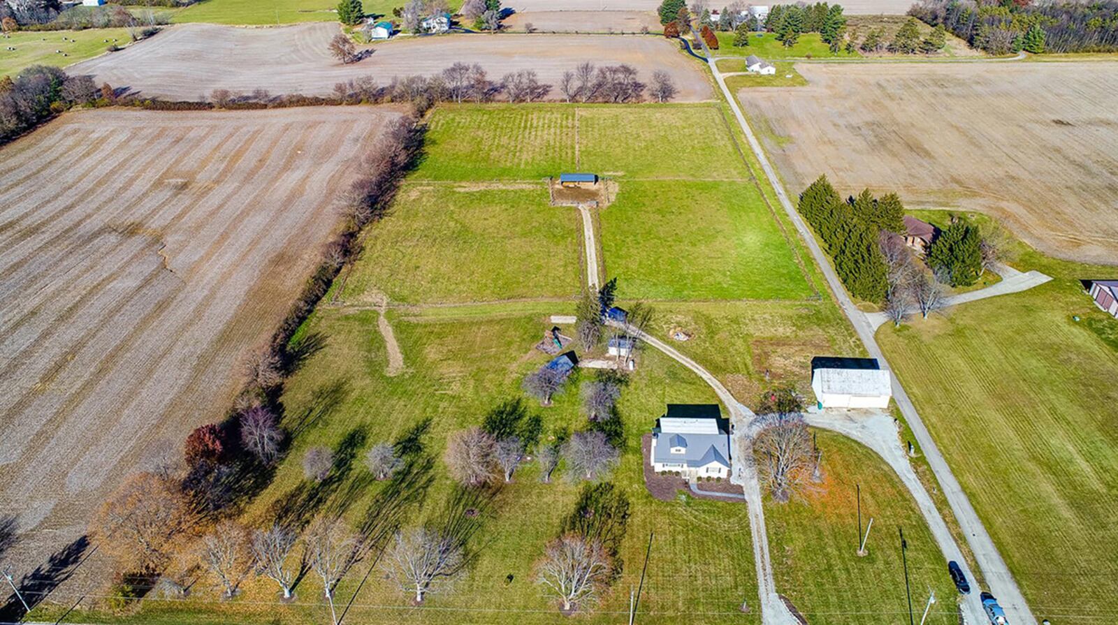 The farmhouse is on 10 acres and features multiple pastures and outbuildings, including one with an integrated garage. CONTRIBUTED PHOTO