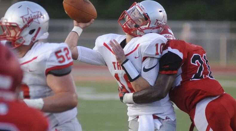 Troy QB Sam Coleman is leveled by Trotwood’s Jayvanare Nelloms. Trotwood-Madison defeated Troy 48-0 in a Week 1 high school football game. MARC PENDLETON / STAFF