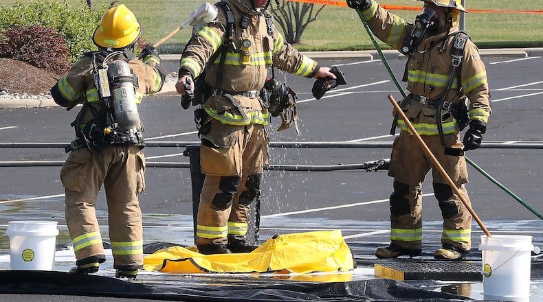 A firefighter is decontaminated in the parking lot of Springfield Regional Medical Center Friday. The Clark County Local Emergency Planning Committee hosted a training event Friday in the parking lot of Springfield Regional Medical Center. The training involved a simulated vehicle accident with a hazmat spill staged in one portion of the parking lot. BILL LACKEY/STAFF