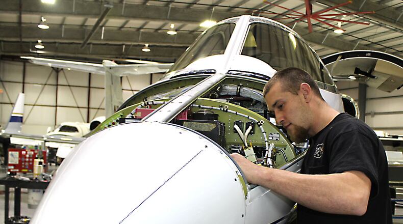 Spectra Jet employee Trevyn French inspects the emergency battery on a 31A Lear Jet at the companies facility at the Springfield-Beckley Municipal Airport. Jeff Guerini/Staff