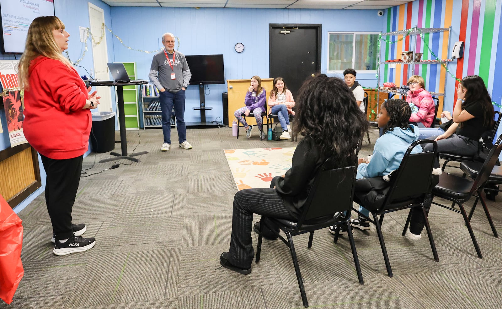 Donna Beer (far left), a volunteer, talks to Ruskin Elementary School students on Tuesday, Jan. 6, at a Dayton church. Beer was assisting teaching students during a  LifeWise Academy class. LifeWise is a Hilliard-based organization that offers Christian education to public school students during school hours at sites near school buildings. BRYANT BILLING/STAFF