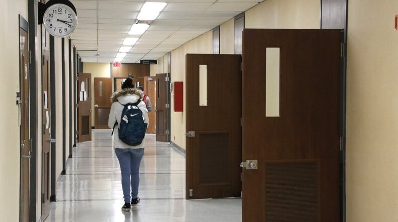 A student walks down one of the hallways in Rhodes Hall Wednesday, March 28, 2018. Clark State Community College plans to renovate and modernize Rhodes Hall. Bill Lackey/Staff
