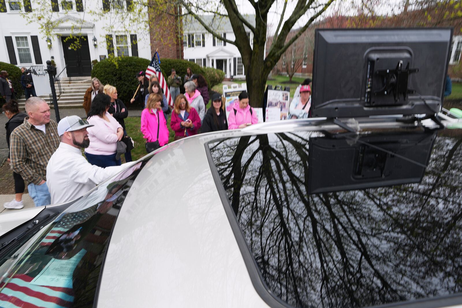 Supporters of Karen Read gather outside a buffer zone and watch Read's trial at Norfolk Superior Court, Tuesday, April 22, 2025, in Dedham, Mass. (AP Photo/Charles Krupa)