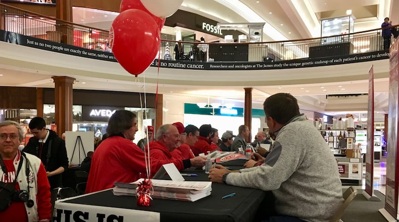 Jim Day signs autographs on the first day of the Reds Winter Caravan 2018.