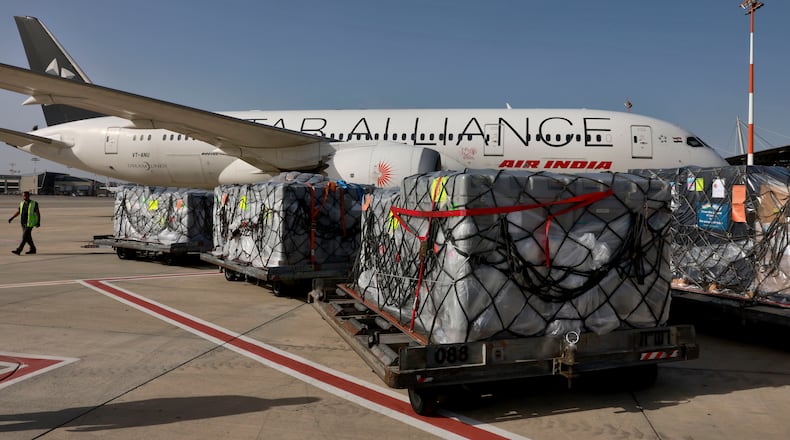 FILE -Workers load medical aid onto an Air India plane to be flown to India, at Ben Gurion Airport near Tel Aviv, Israel, May 4, 2021. (Menahem Kahana/Pool Photo via AP, File)