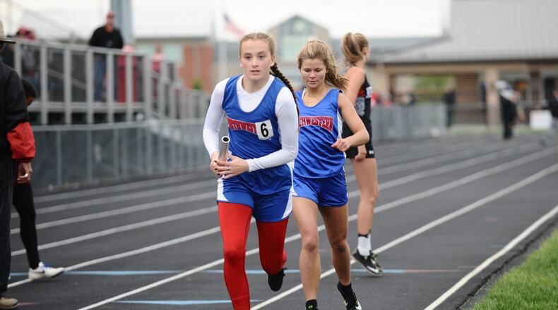 Northwestern’s Stephanie White, taking the baton from teammate Marley Hosier during the 1,600-meter relay, won the Mad River Division’s 400 dash at the Central Buckeye Conference meet on Friday. Greg Billing / Contributed