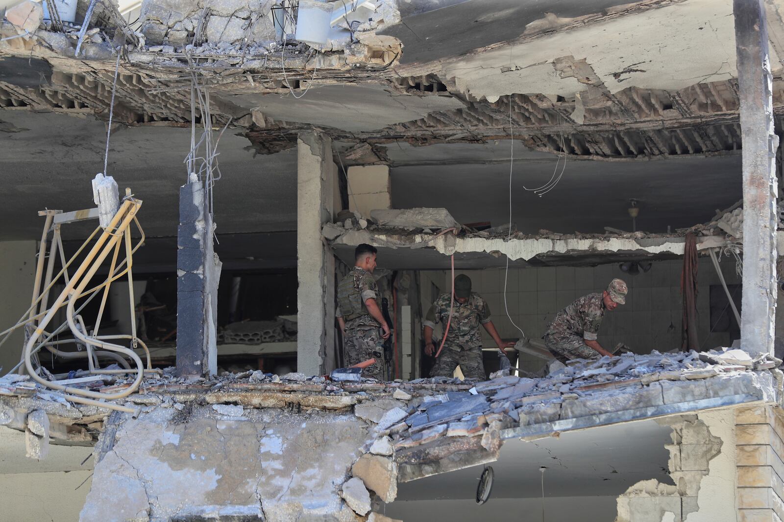 Lebanese army soldiers inspect a destroyed house that was hit in an Israeli airstrike in Nabatieh town, south Lebanon, Friday, June 27, 2025. (AP Photo/Mohammed Zaatari)