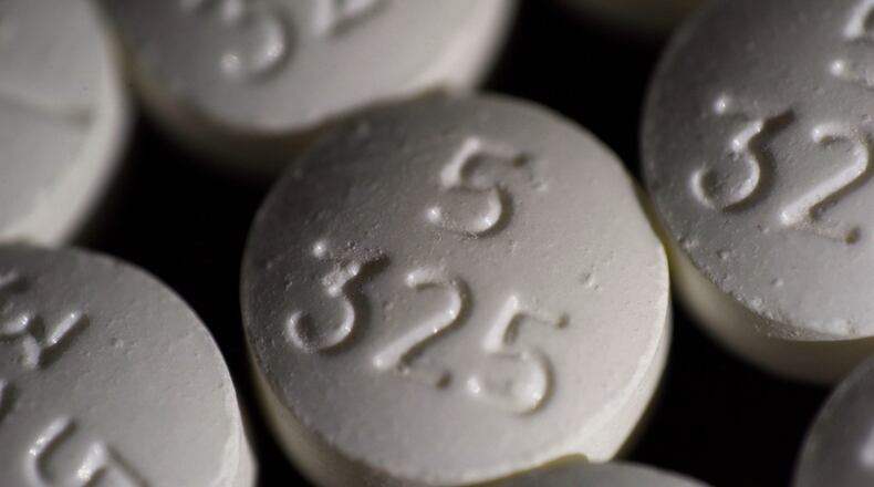 FILE - An arrangement of pills of the opioid oxycodone-acetaminophen in New York. Idaho officials on Friday, May 13, 2022, agreed to a $119 million settlement with drugmaker Johnson & Johnson and three major distributors over their role in the opioid addiction crisis. (AP Photo/Patrick Sison, File)