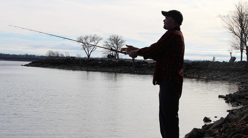 Derrick Brashears spent the early afternoon of Thursday fishing with his daughter Amber at the C.J. Brown Dam and Reservoir in Buck Creek State Park. He said the warm weather brought them out that day as large portions of the reservoir have thawed due to a bout of warm weather this week. HASAN KARIM/ Staff