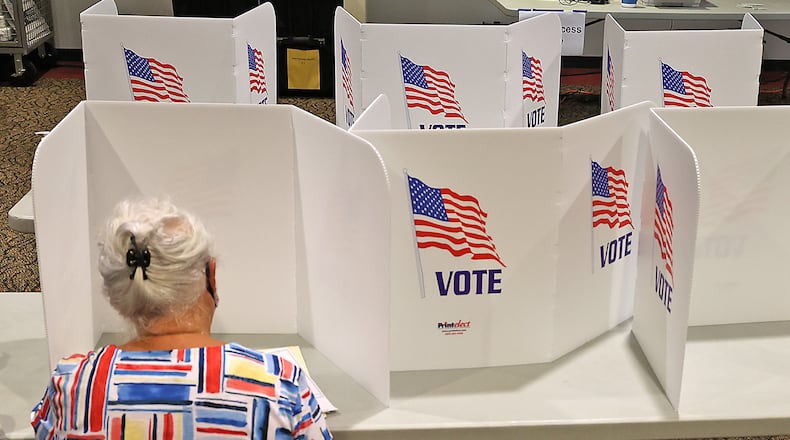 A woman casts her vote at the First Christian Church on Middle Urbana Road in Clark County. BILL LACKEY/STAFF