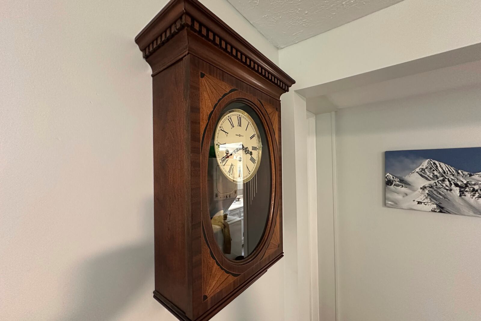 In this photo provided by Michael Hogan, a Howard Miller Co. clock hangs on a wall in a home in Muskegon, Mich., on July 11, 2025. (Michael Hogan via AP)