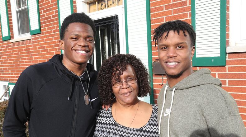 Vickie Arnold with her grandson’s Tavione Arnold and DaeShawn Jackson. BILL LACKEY/STAFF