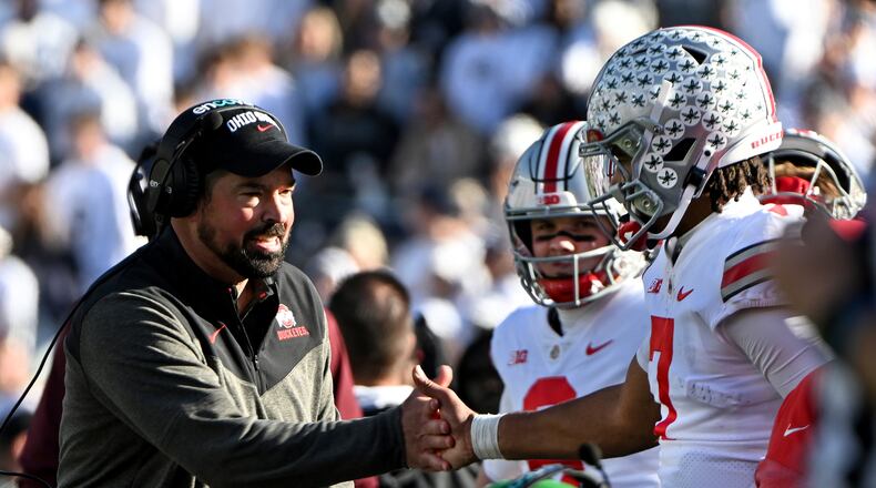 Ohio State head coach Ryan Day celebrates a touchdown with quarterback C.J. Stroud during the fourth quarter of an NCAA college football game against Penn State, Saturday, Oct. 29, 2022, in State College, Pa. Ohio State won 44-31. (AP Photo/Barry Reeger)