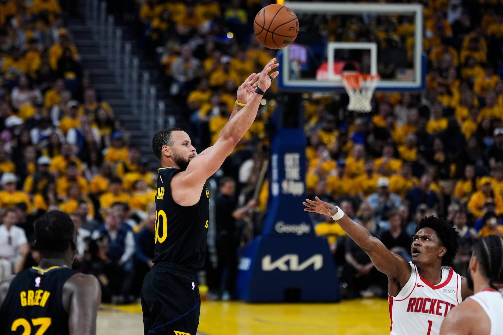 Golden State Warriors guard Stephen Curry (30) shoots a 3-point basket over Houston Rockets forward Amen Thompson (1) during the first half of Game 6 of an NBA basketball first-round playoff series Friday, May 2, 2025, in San Francisco. (AP Photo/Godofredo A. Vásquez)