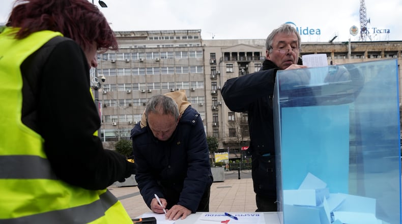 Serbia's protesting university students collect signatures for their request for an early parliamentary election, in Belgrade, Serbia, Sunday, Dec. 28, 2025. (AP Photo/Darko Vojinovic)