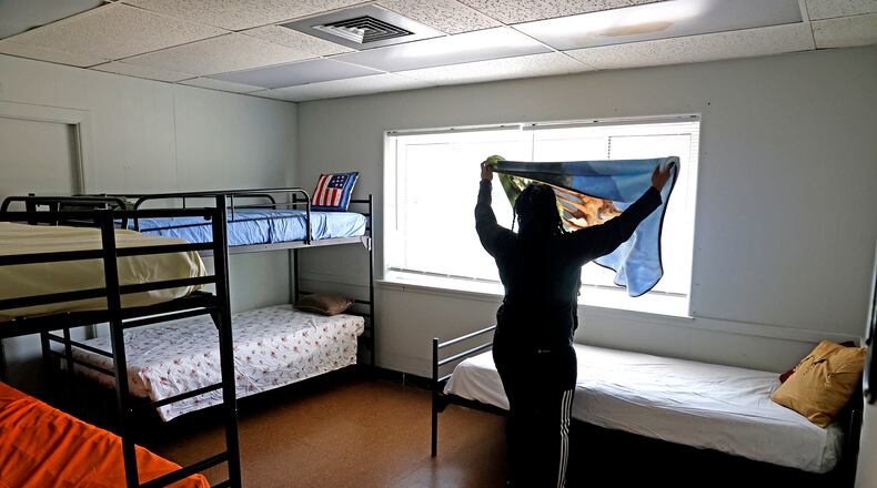 Taylor Cobb makes the beds in one of the family size rooms Tuesday, Sept. 5, 2023, as she helps get Norm's Place homeless shelter ready to reopen. BILL LACKEY/STAFF