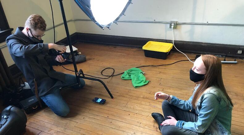 Kolton Rice, left, owner of OpenEye Studios, photographs Mary Cunningham for a series of posters that will be featured in an upcoming anti-vaping campaign being created by local youth service group B.A.T.S. Photo by Brett Turner