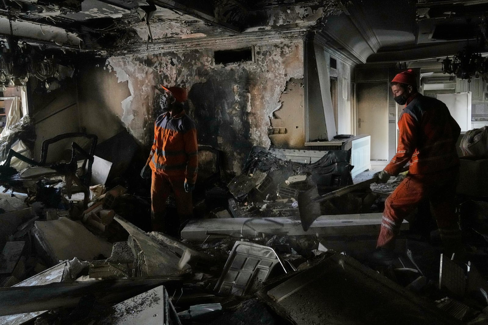 Workers clear rubble of a damaged building, in Tehran, Iran, Wednesday, June 25, 2025, after an Israeli strike on early Tuesday. (AP Photo/Vahid Salemi)
