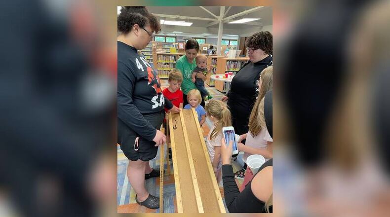 August Flack, and Luca Talbott supervise one of the heats while the coaches and managers cheer the worms on. Photo by Pam Cottrel