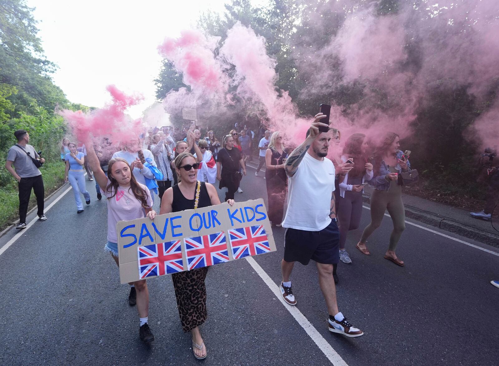 Protesters demonstrate near the Bell Hotel in Epping, northeast of London, Sunday, July 20, 2025. (Yui Mok/PA via AP)
