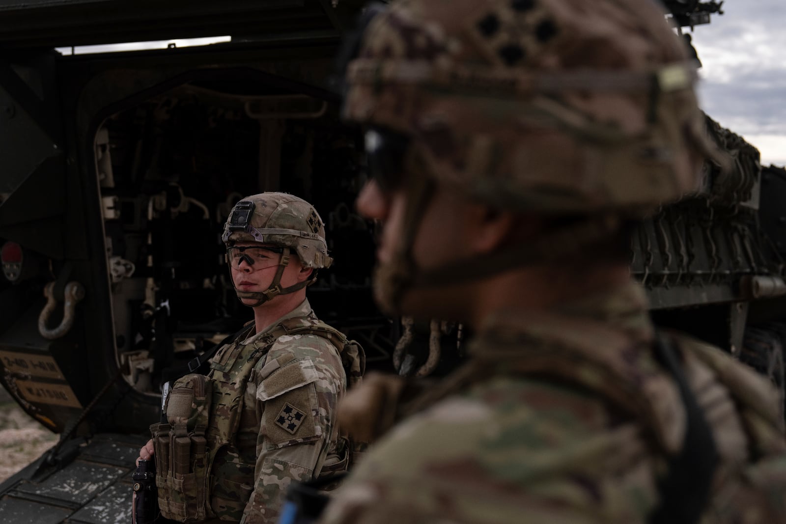U.S Army Sgt. Brenden Richards monitors the area while standing next to a Stryker combat vehicle Wednesday, July 23, 2025, in Sunland Park, N.M. (AP Photo/Jae C. Hong)