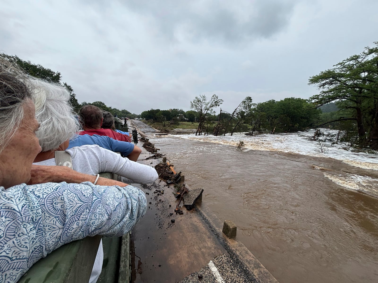 Rescue workers transport residents away from Hunt, Texas, at 6:38 p.m. on Friday, July 4, 2025, after floodwaters from the Guadalupe River devastated their town. (Shabd Simon-Alexander via AP)