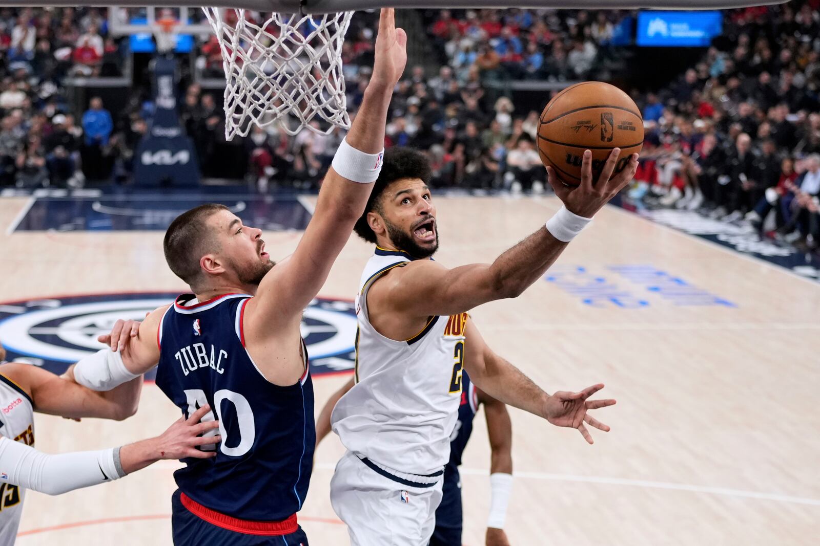 Denver Nuggets guard Jamal Murray, right, shoots as Los Angeles Clippers center Ivica Zubac defends during the first half in Game 4 of an NBA basketball first-round playoff series Saturday, April 26, 2025, in Inglewood, Calif. (AP Photo/Mark J. Terrill)